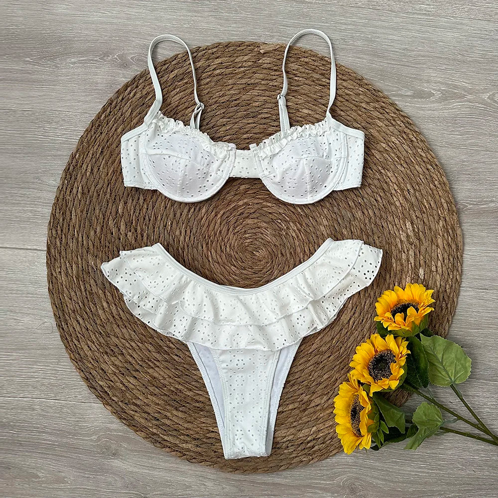 Flat lay of white frill bikini with sunflowers