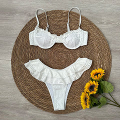Flat lay of white frill bikini with sunflowers