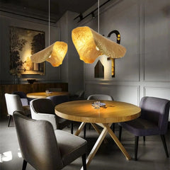 A trendy restaurant bar featuring multiple copper lotus leaf pendant lights creating an inviting atmosphere. B