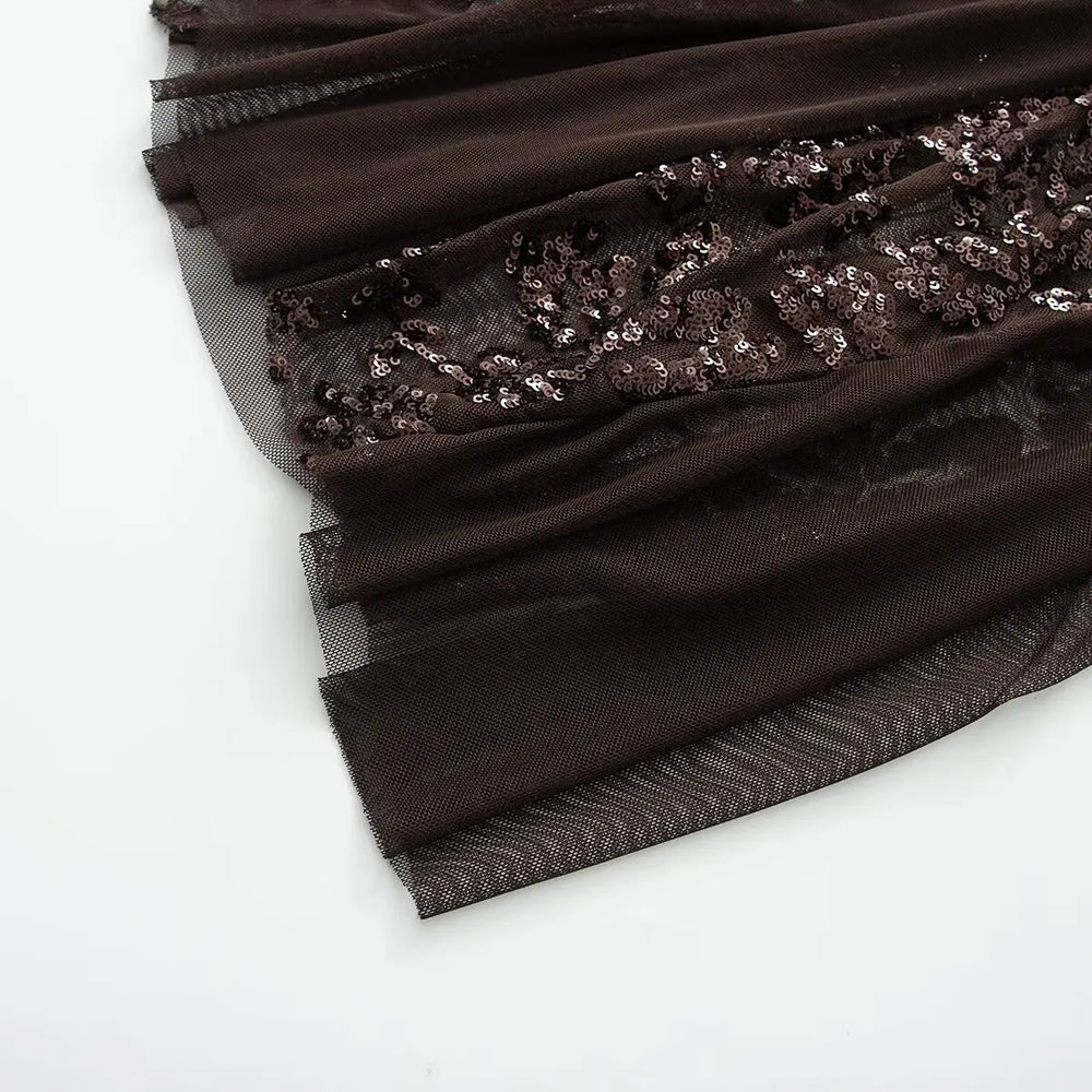 Black fabric with sequin detailing on a white background