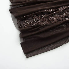 Black fabric with sequin detailing on a white background