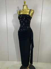 Close-up of the beaded embellishments on the bodice of a black spaghetti strap dress