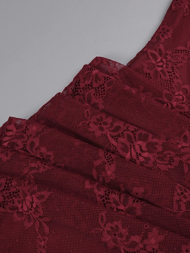 Close-up of red lace fabric on a gray background