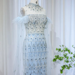 Mannequin displaying  the light blue mermaid evening gown with cape sleeves, showcasing its flattering silhouette and graceful train.  Golden Atelier 3