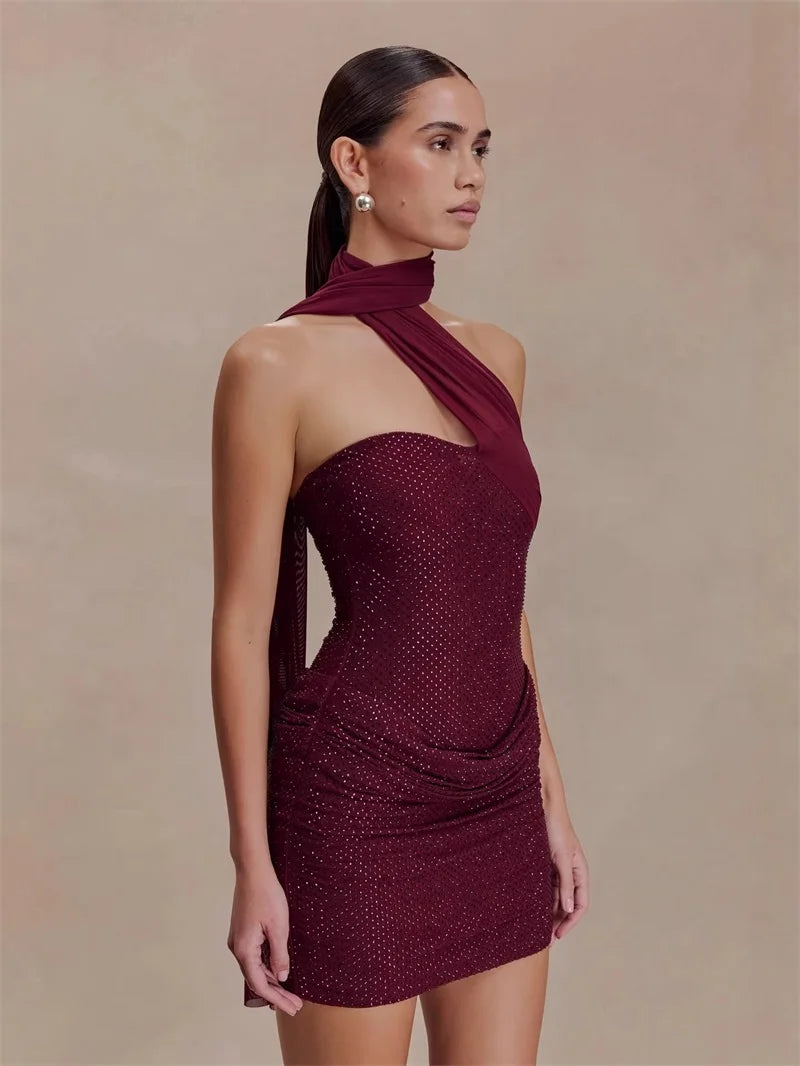 Close-up of the halter neckline and crystal embellishments on a burgundy mini dress.