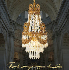 French vintage copper chandelier hanging in an ornate ceiling