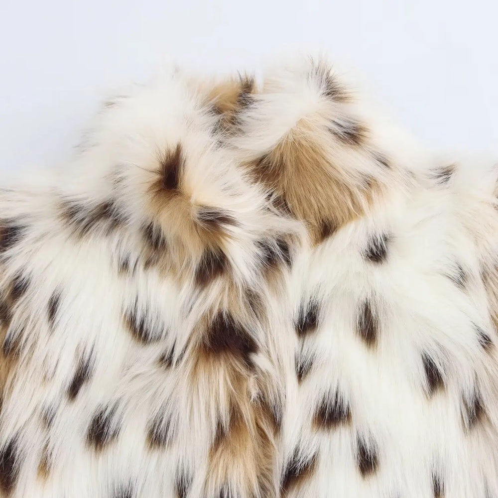 Close-up of a fur texture with white, brown, and black colors on a light gray background.