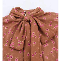 Close-up of floral print bow tie neck blouse neckline