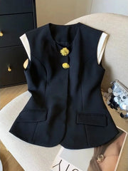 Black vest with gold buttons on a chair