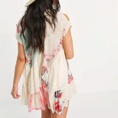 Woman wearing a floral kimono-style garment on a white background