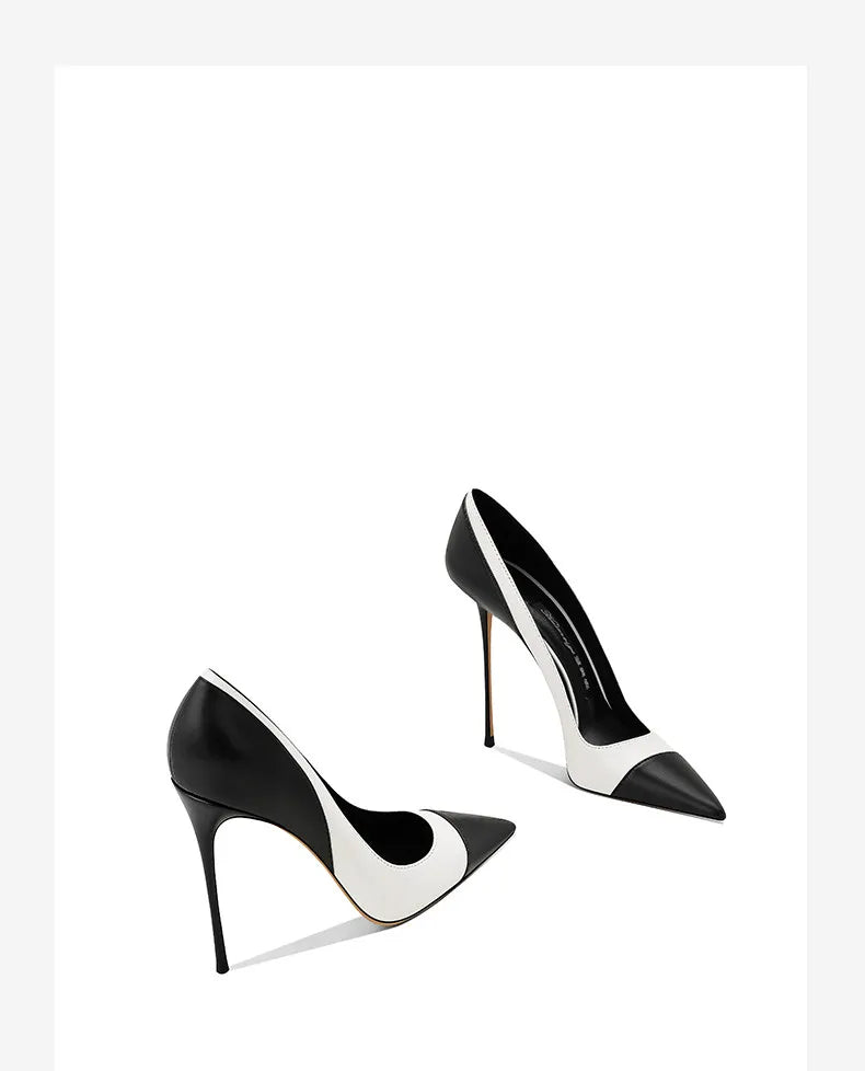 Pair of black and white pointed stiletto heel pumps