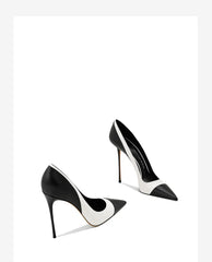 Pair of black and white pointed stiletto heel pumps