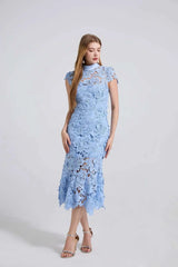 Woman wearing a light blue lace dress on a white background