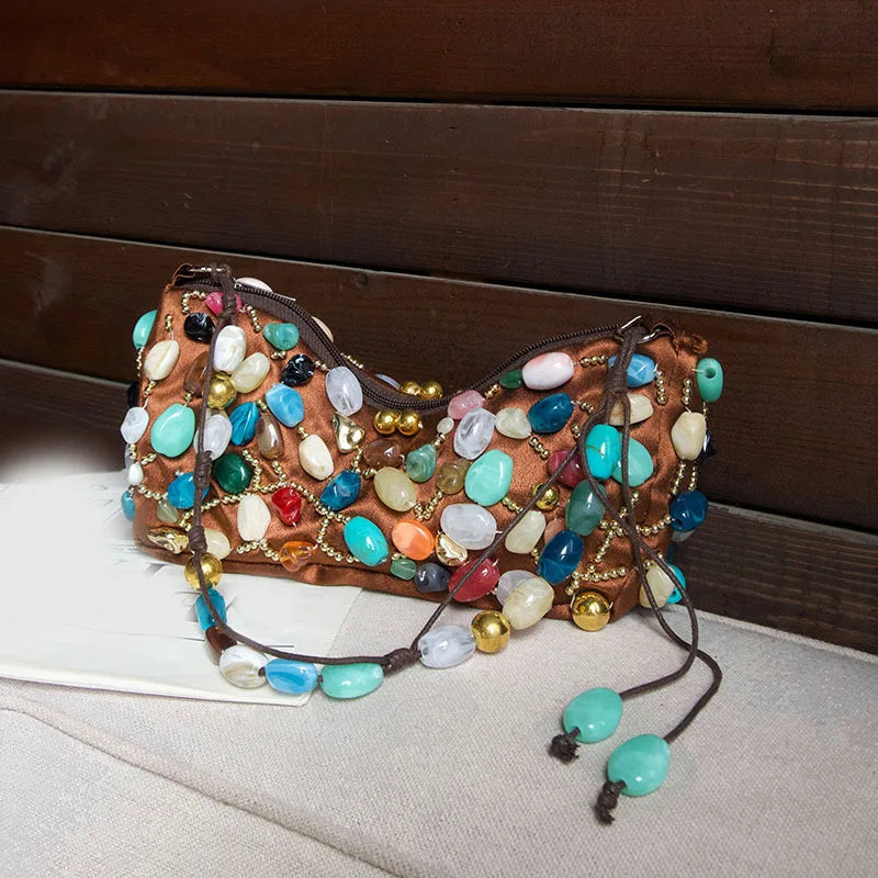 Brown satin shoulder bag adorned with colorful stones and gold beads.