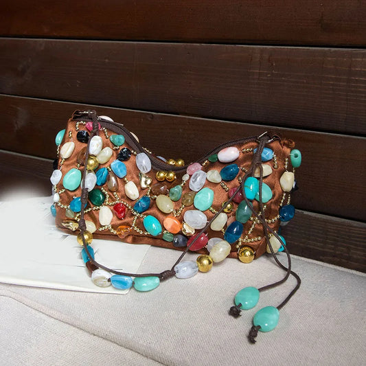 Brown satin shoulder bag adorned with colorful stones and gold beads.
