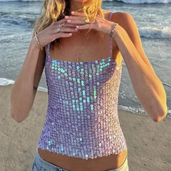Woman wearing a sequined top on a beach