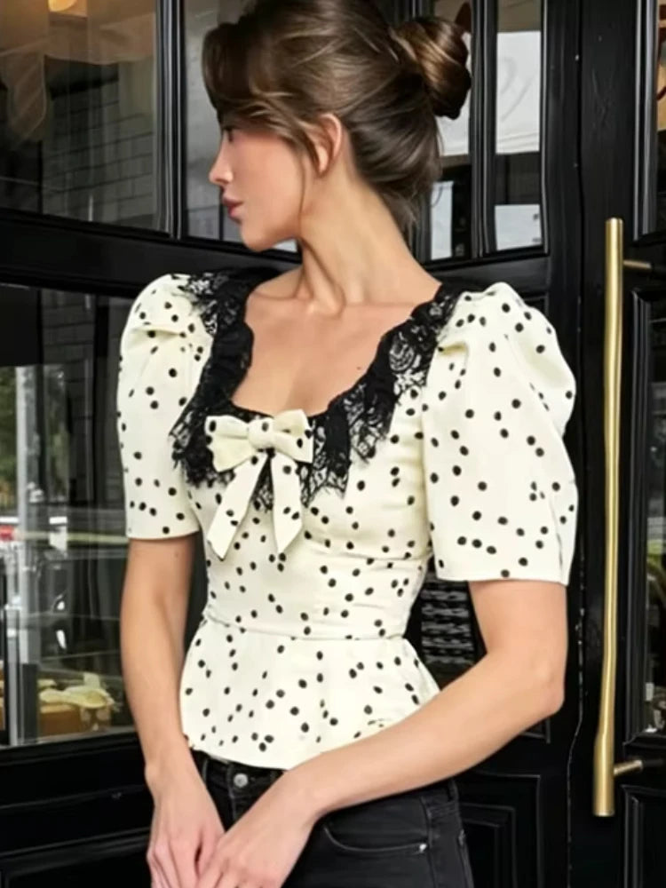 Side profile of polka dot peplum top with lace detail