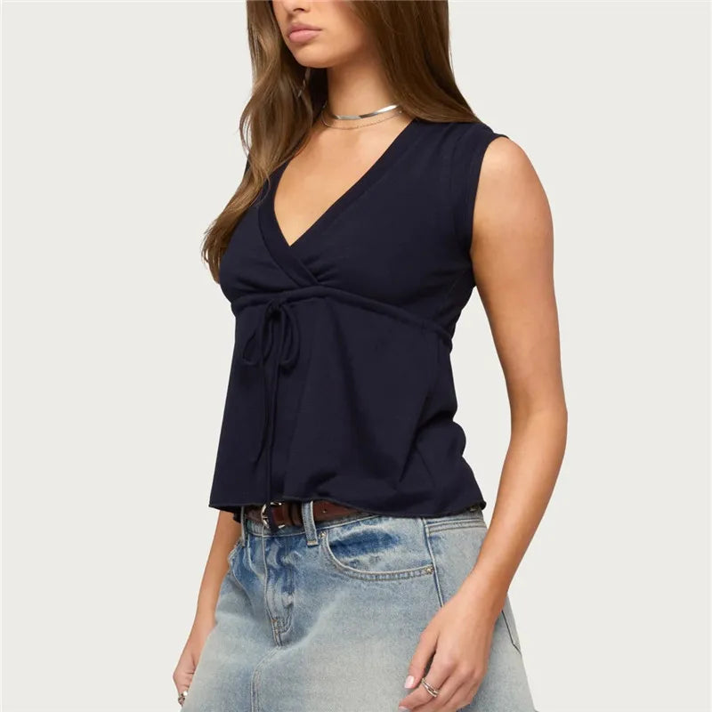 Sleeveless wrap front top with tie waist and peplum hem