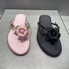 Pair of pink and black floral embellished flip-flops