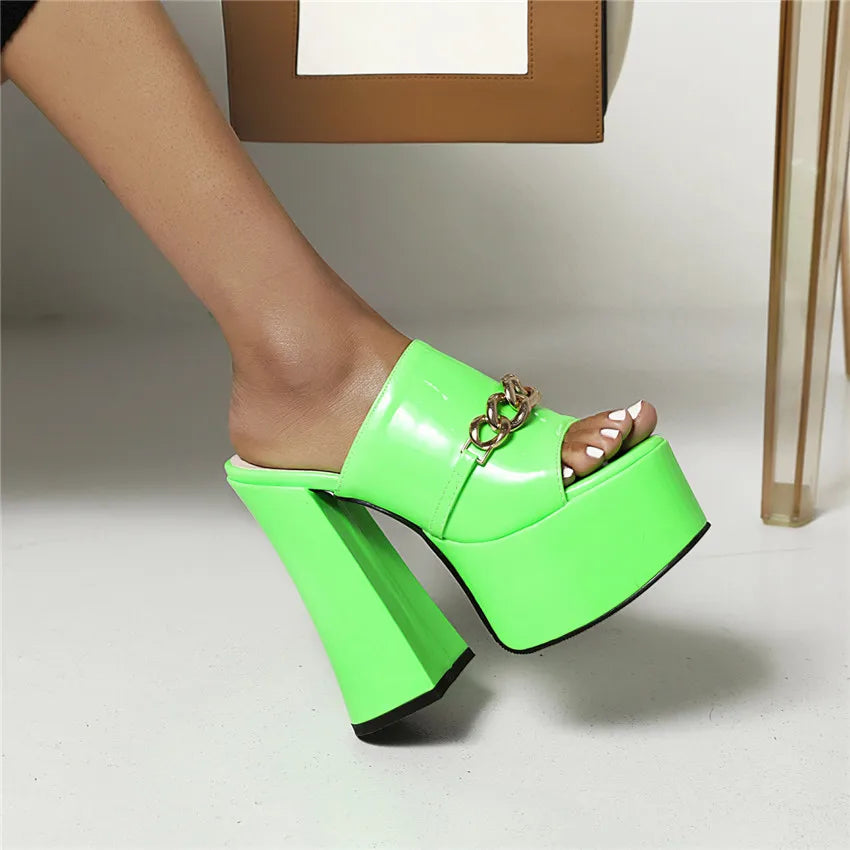Close-up of green chunky heel platform slides with metal chain
