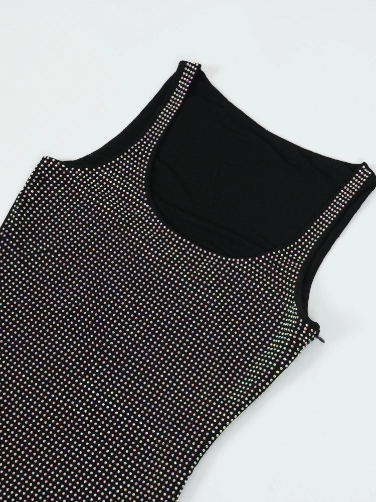 Black tank top with white polka dots on a white background