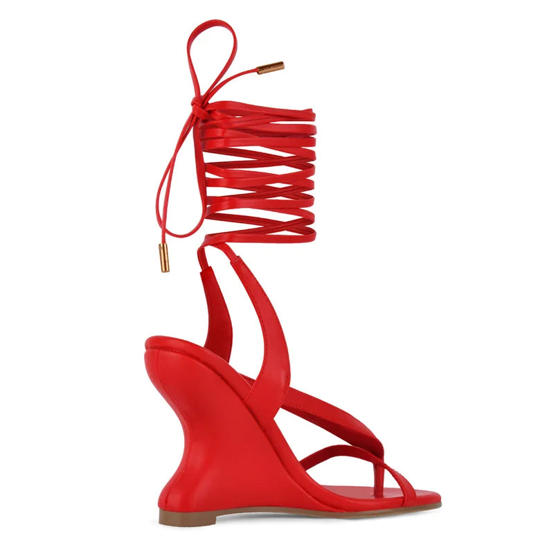 Side view of red lace-up wedge sandals