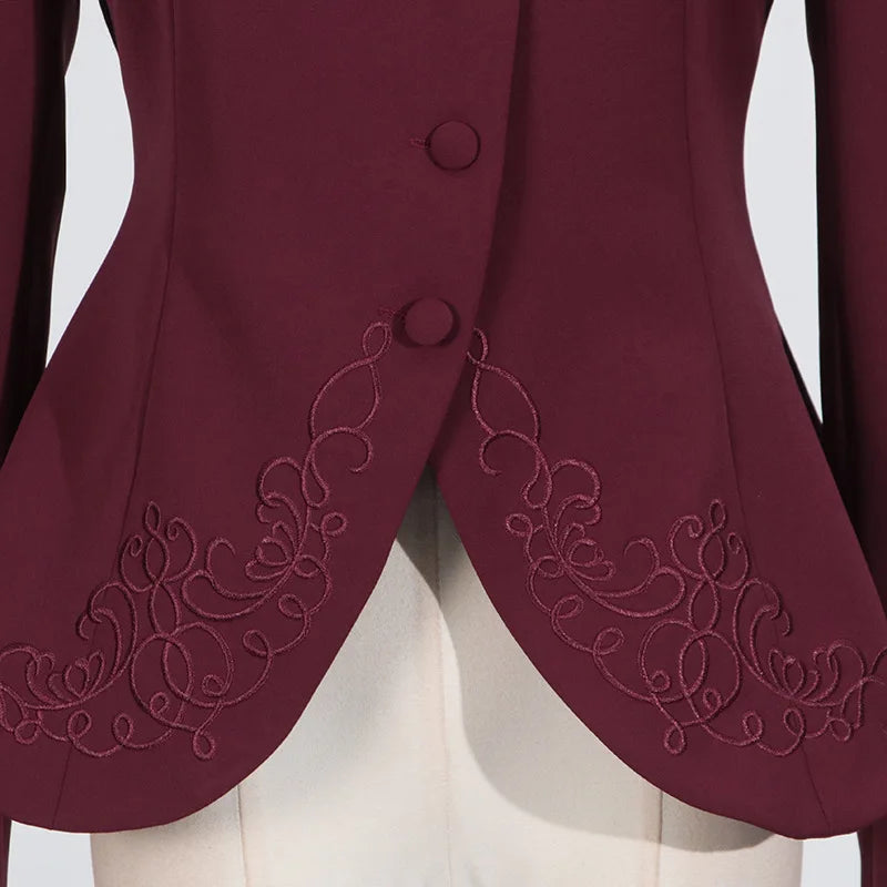 Maroon blazer with intricate embroidery on a plain background
