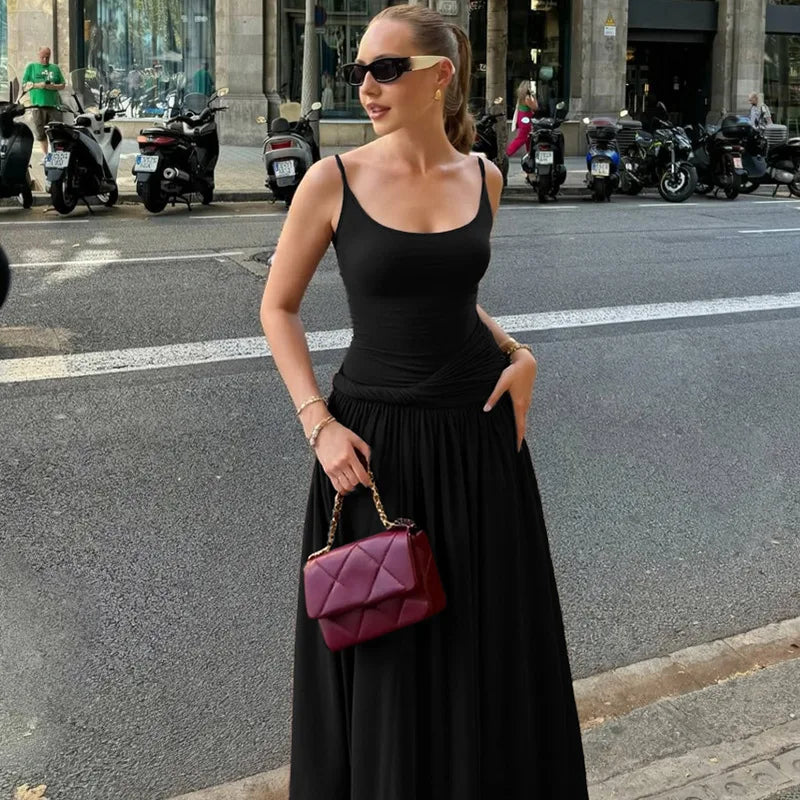 Woman in black outfit with a purple handbag on a city street