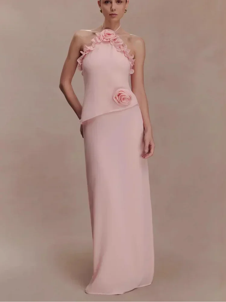 Pink evening gown with floral details on a plain background