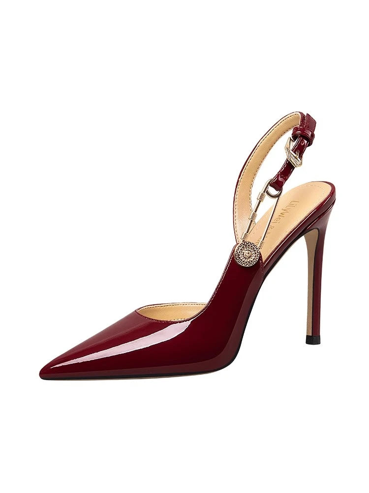 Red high-heeled shoe with a gold buckle on a white background