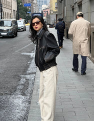 A woman wearing a stylish faux shearling jacket, perfect for spring. Golden Atelier 4