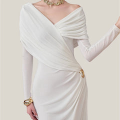 White evening gown with long sleeves on a plain background
