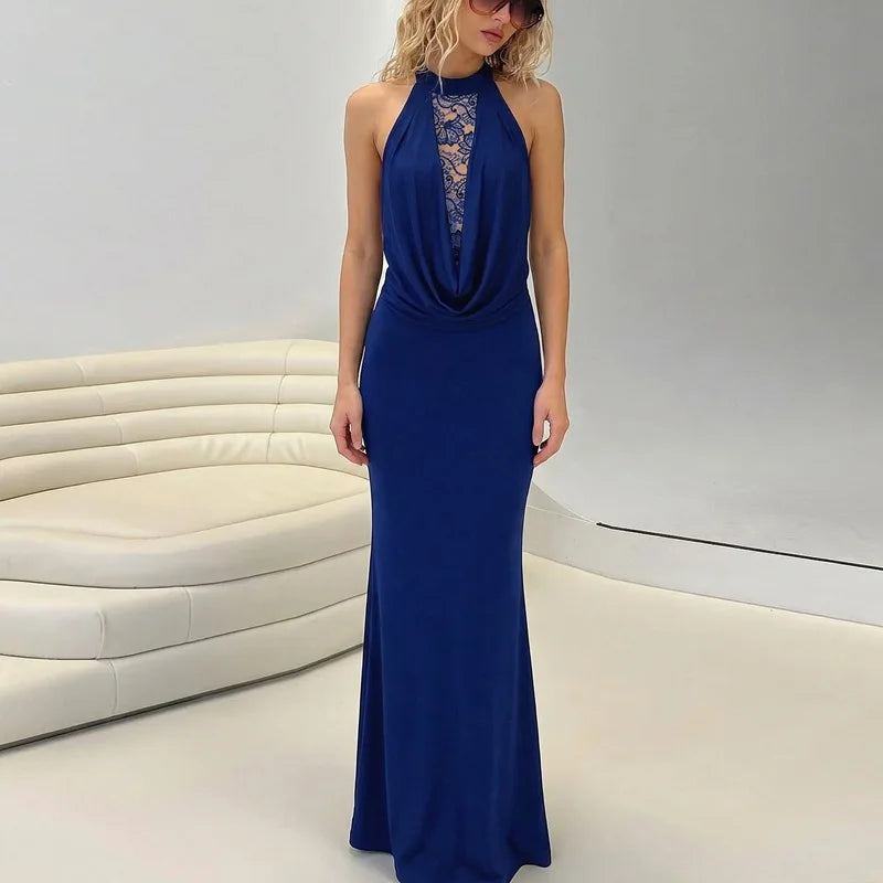 Woman wearing a blue evening gown in a modern indoor setting