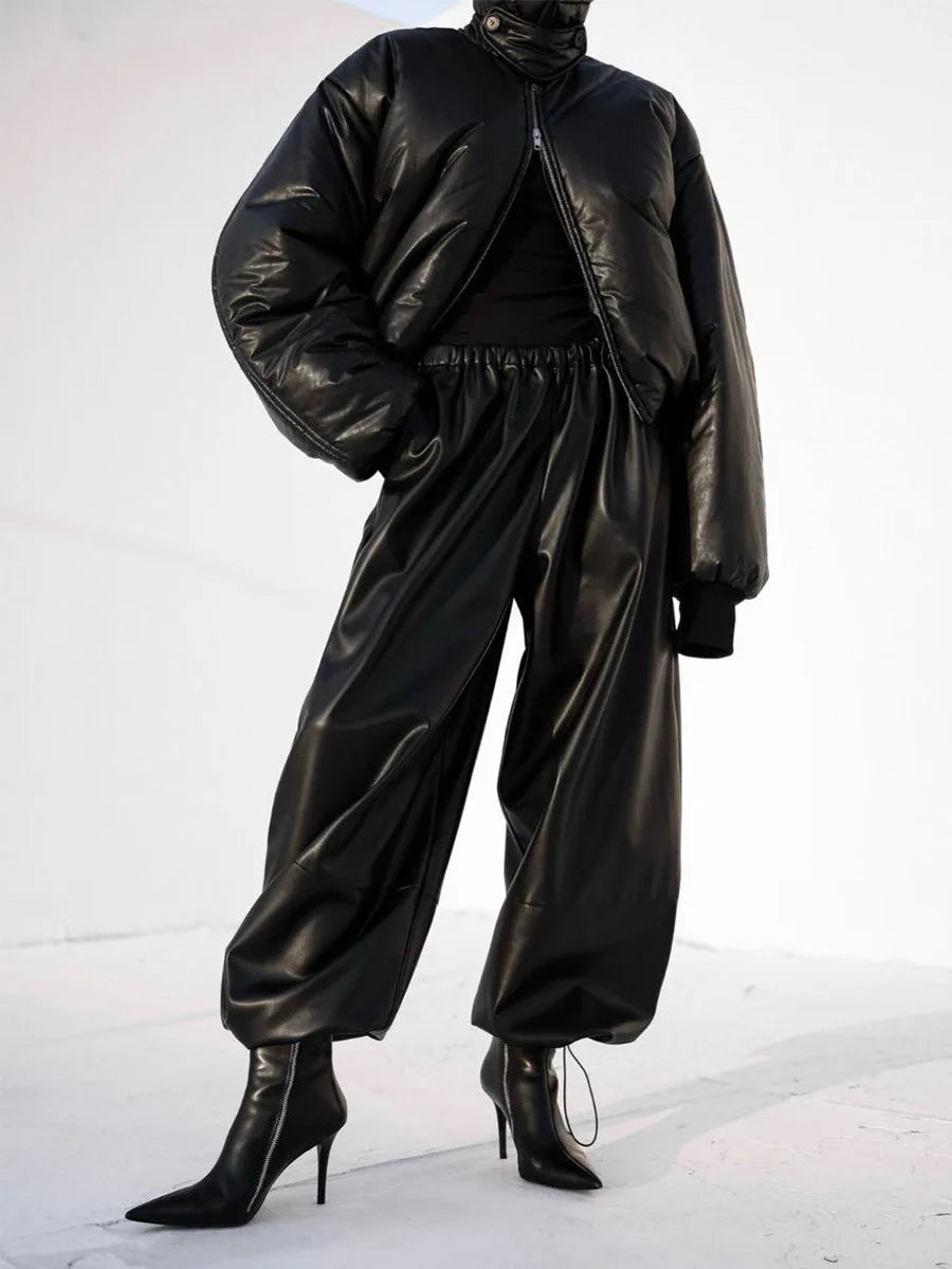 Person wearing a black leather outfit on a white background