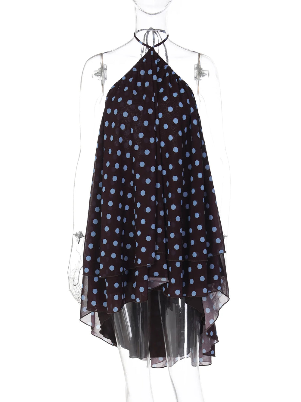 Mannequin wearing a black dress with blue polka dots and sheer black layers on a white background