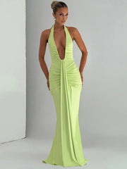 Woman wearing a bright green evening gown against a gray background