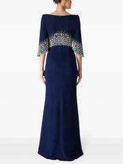 Navy blue evening gown with silver embellishments on a white background