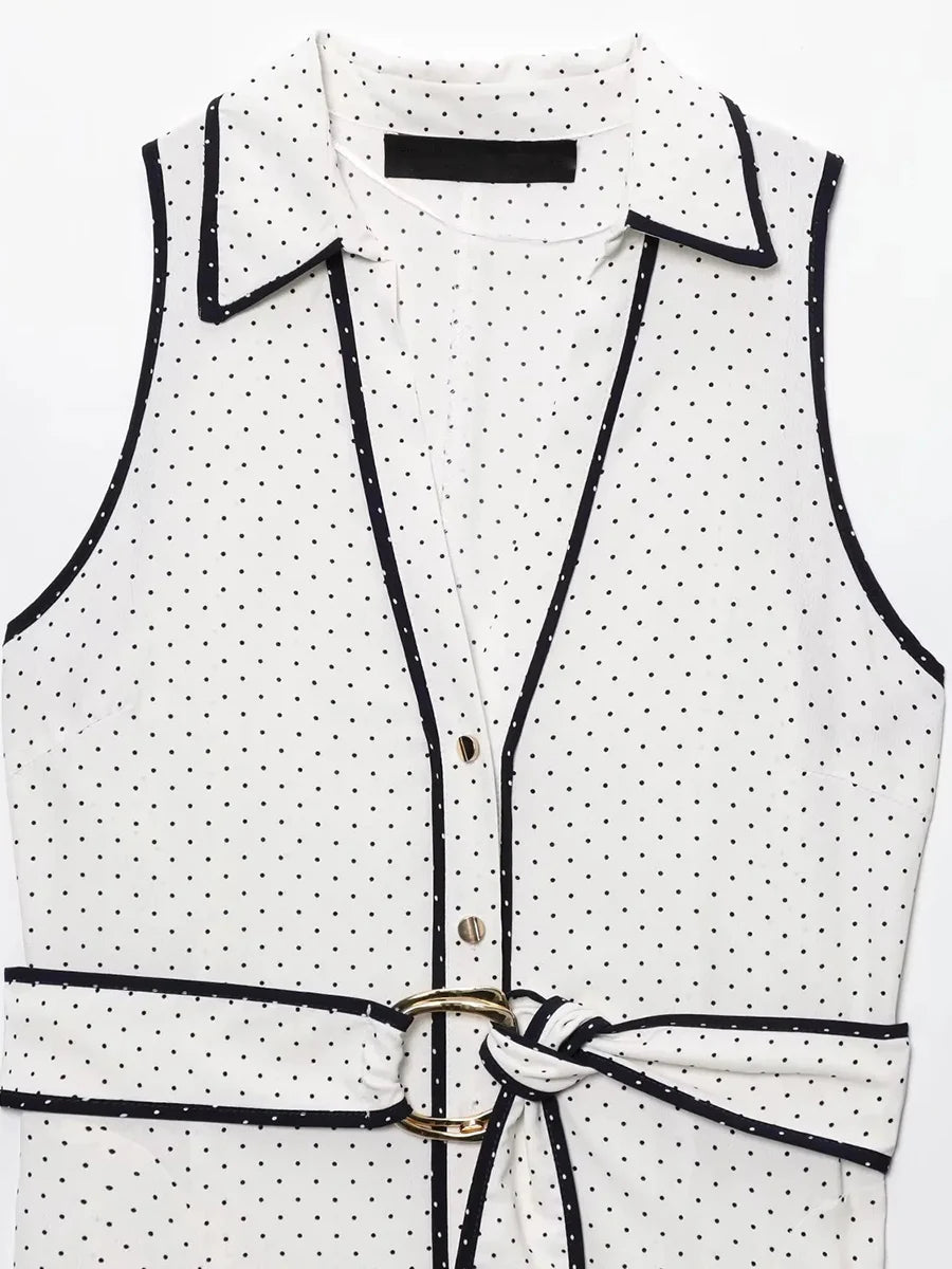 White vest with black polka dot pattern and a belt on a white background