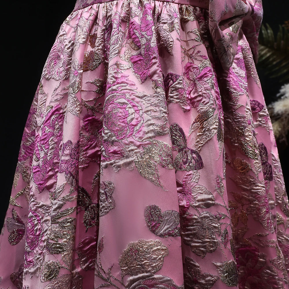 Close-up of a pink and silver floral patterned fabric.