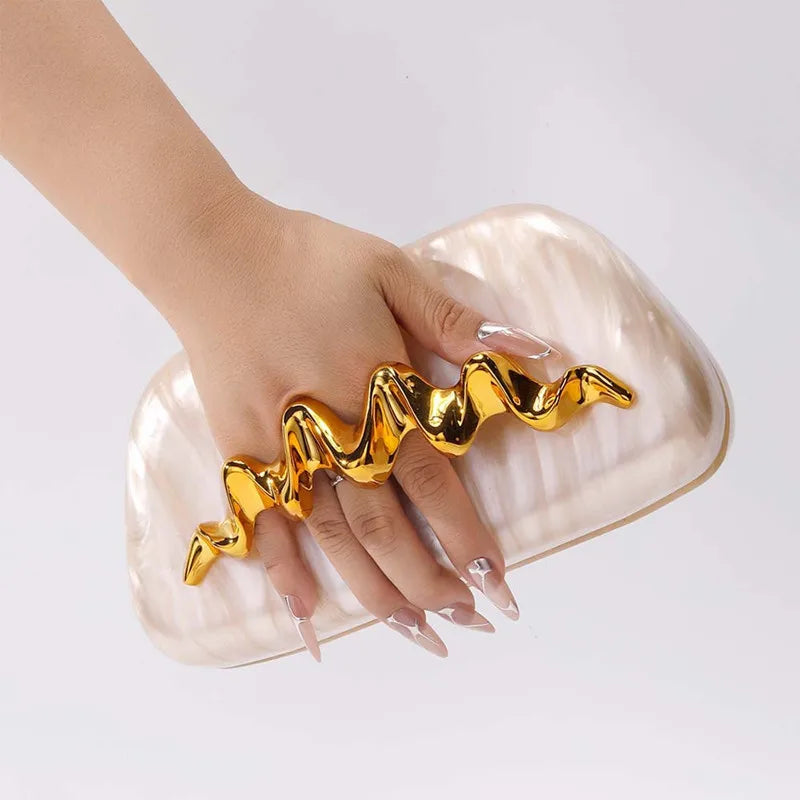 Sculptural wave handle clutch bag with ivory acrylic exterior