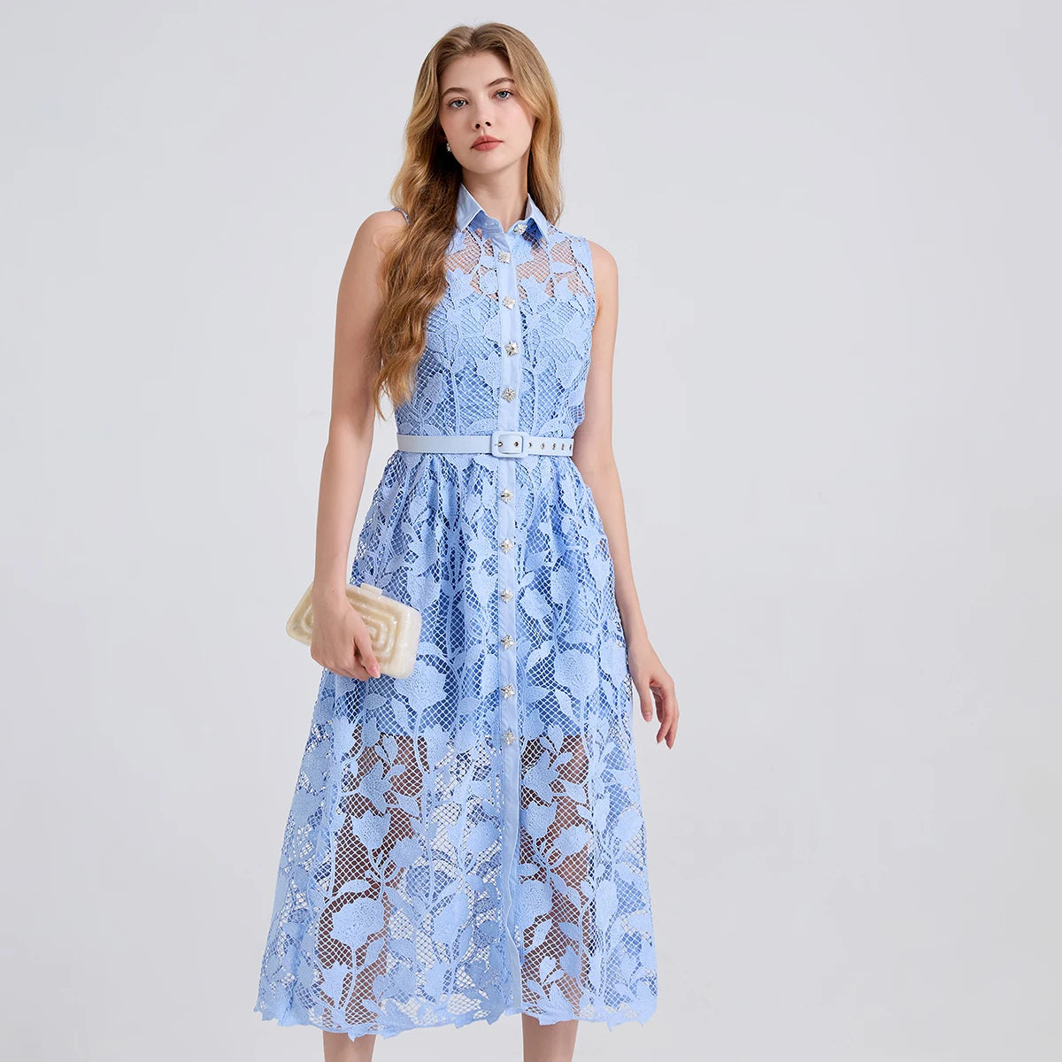 Woman wearing a light blue lace dress on a white background