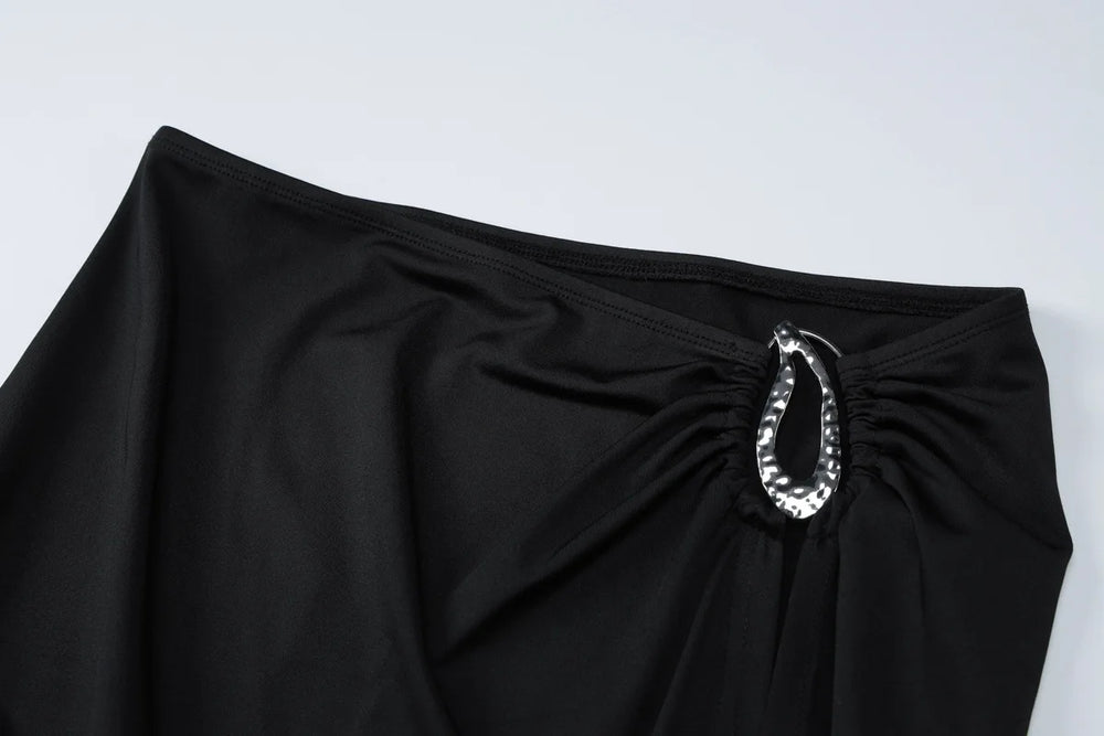 Black skirt with a silver embellishment on a white background