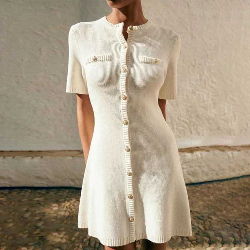 White knitted dress with buttons on a neutral background