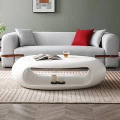 Modern living room with a gray sofa, white coffee table, and decorative items.