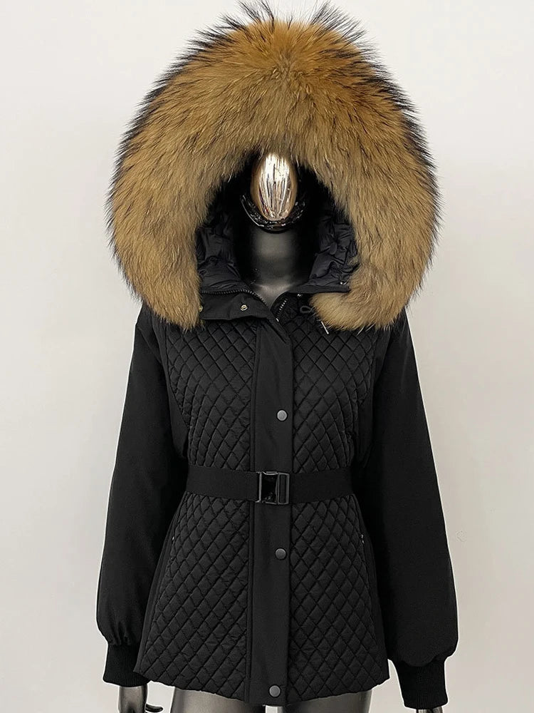 Black quilted jacket with a large fur hood on a mannequin against a white background
