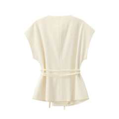 Cream-colored sleeveless top with a tie detail on a white background