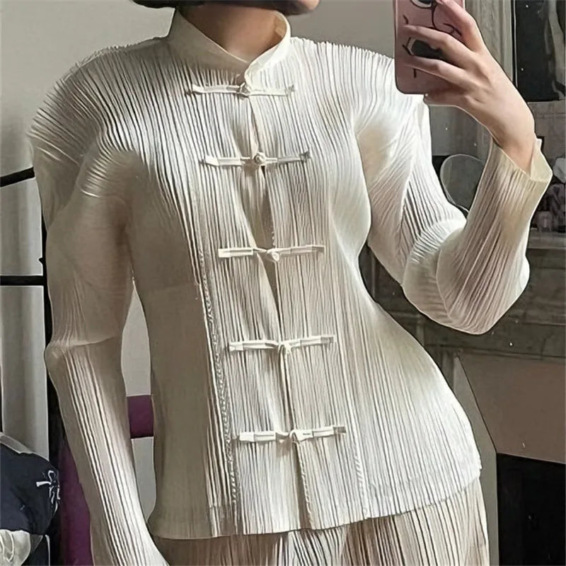 Model wearing a white mandarin collar pleated top