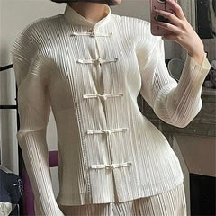 Model wearing a white mandarin collar pleated top