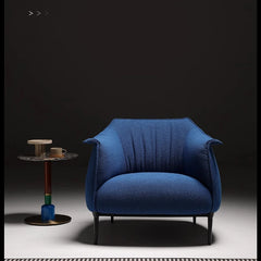 Bold blue accent chair next to side table in contemporary room