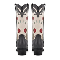 Black and white cowboy boots with red floral patterns on a white background
